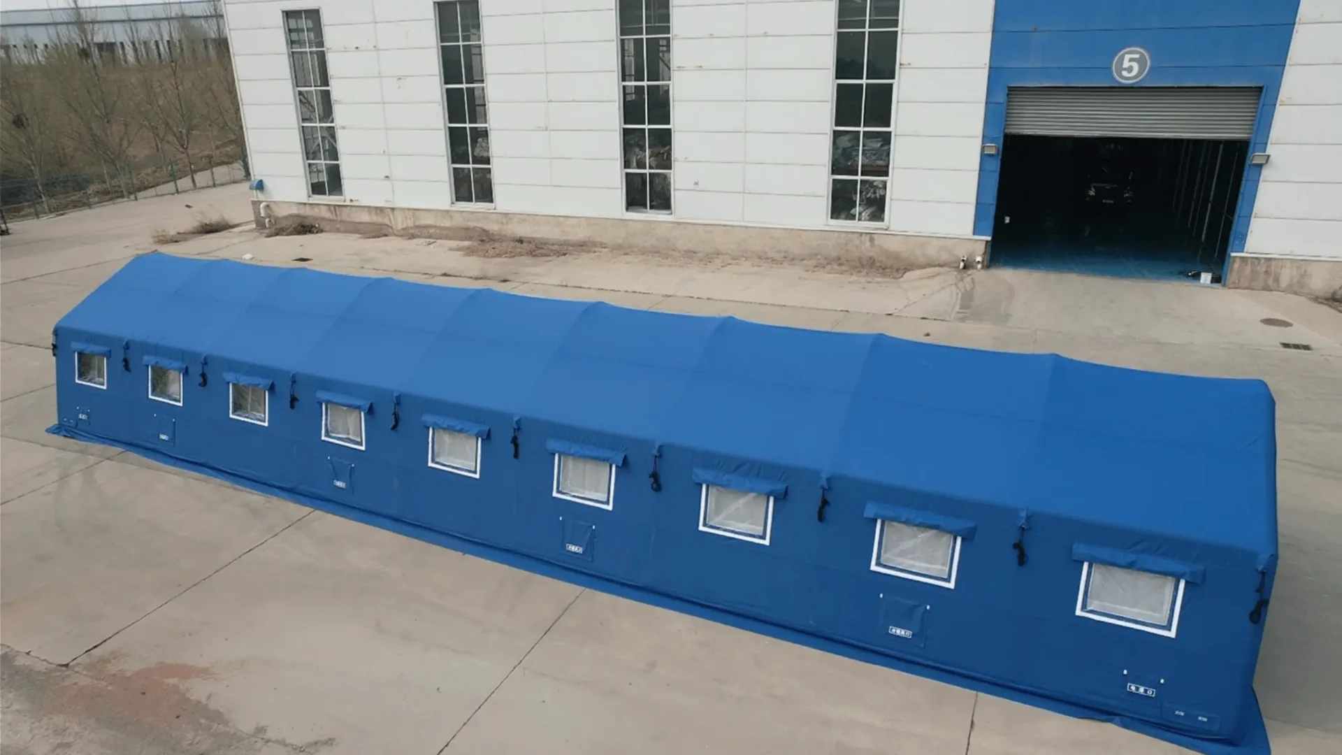 Official emergency relief shelter with enclosed walls and multiple protected window openings